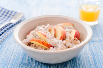 Homemade Porridge with Buckwheat jogurt and sliced apple in bowl