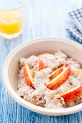 Homemade Porridge with Buckwheat jogurt and sliced apple in bowl