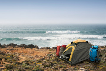 Tourist camp with tent and car on the ocean