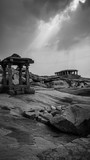 little stone temple with dramatic mystic sky in hampi india karnakata black and white