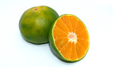 green oranges on white background - healthy fruit