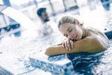 Portrait of beautiful woman relaxing in swimming pool