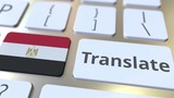 TRANSLATE text and flag of Egypt on the buttons on the computer keyboard. Conceptual 3D animation