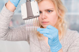 Young attractive woman work with PCR dispenser in the laboratory of genetics