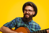 Hipster with guitar looking away