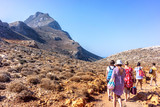 Tourists descend from the mountains to the beach of Balos in Crete, Greece