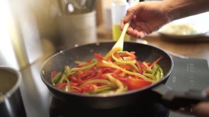 Closeup of food being cooked in fried pan (slow motion)