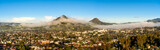 Cityscape in Morning Light and Mountain Peaks