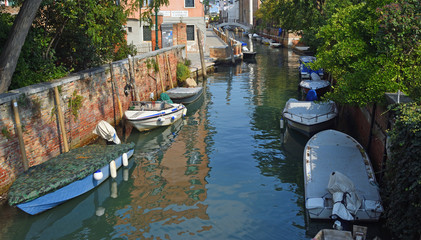 Quiet canal with boats Venice.