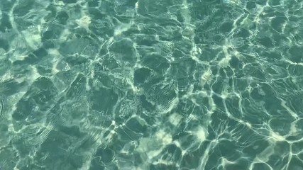 turquoise sea water on paradise beach, texture surface background in sunny day