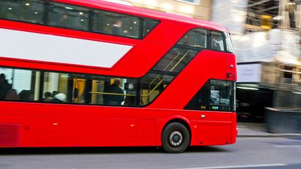 3745_One_of_Londons_red_bus_passing_by_the_street.jpg