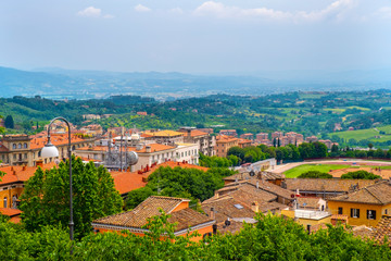 Perugia, Italy - Panoramic view of the Perugia historic quarter with medieval houses and Umbria valleys and mountains in background