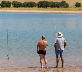 Two men fishing for fishing on the lake