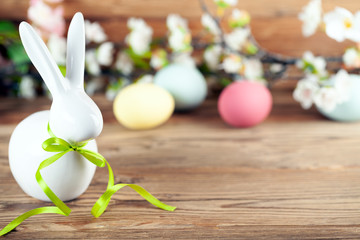 Osterhase mit bunten Ostereiern und Blumen