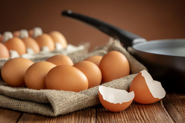 eggs with pan on wooden background