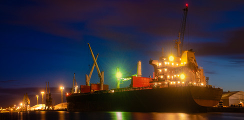 bulk cargo ships in the harbor at night