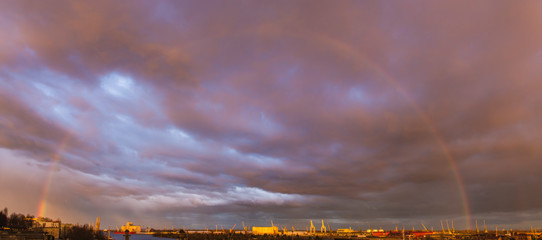 double rainbow against a colorful sky at sunset