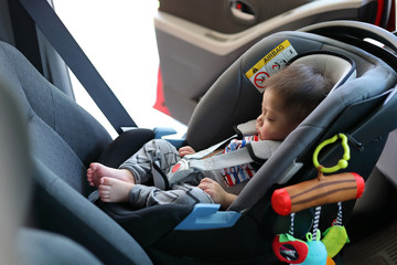 cute baby boy sleeping in car seat safety belt lock protection drive road trip travel