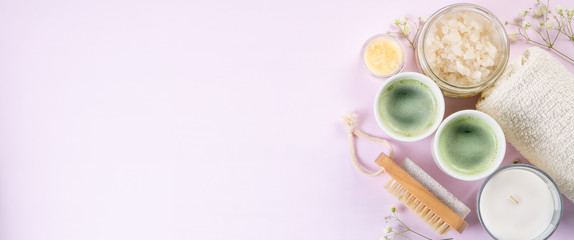 SPA concept - towel, salt, candle on pink background, copy space