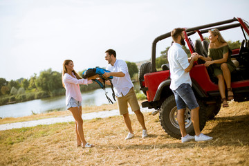 Group of young people having fun on the river bank