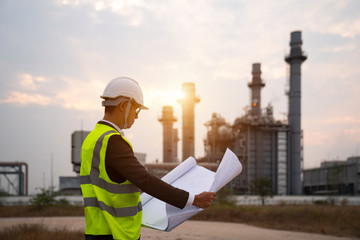 Engineer in uniform and helmet on of background the Construction Site power plant