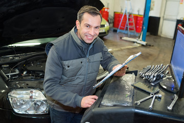 mechanic at car at workshop