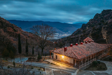 Mtskheta, Georgia. Shio-Mgvime Monastery. Upper Church Of Holy Virgin Or Theotokos, Central Part Of Medieval Monastic ShioMgvime Complex In Limestone Canyon In Autumn Sunset. Colorful Sky Above Famous