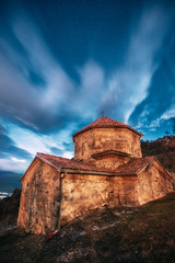 Mtskheta, Georgia. Shio-mgvime Monastery. Church Of Holy Virgin Or Theotokos In Medieval Monastic Shiomgvime Complex In Limestone Canyon Under Autumn Starry Night Sky . Starry Sky Above Famous Place