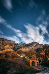 Mtskheta, Georgia. Shio-mgvime Monastery. Medieval Monastic Shio-Mgvime Monastery Shiomgvime Complex In Limestone Canyon Under Autumn Starry Night Sky. Starry Sky Above Famous Place In Limestone