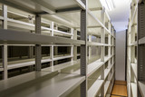 Empty metallic bookshelves with dark background