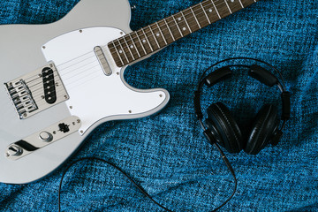 Guitar electric and headphones. Rock music background. Top view