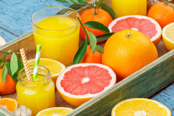 Set of different fruits and glass with fresh orange juice
