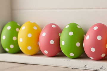 Dotted Easter eggs on wooden background