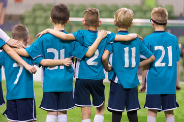 Young Football Players. Young Soccer Team Supporting Friends During Penalty Kicks. Soccer Match For Children. Young Boys Playing Tournament Soccer Match. Youth Soccer Club Footballers