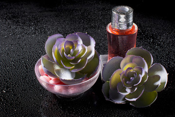 Spa with bottled oils on a black background.