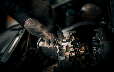 The cylinder block of the four-cylinder engine. Disassembled motor vehicle for repair. Parts in engine oil. Car engine repair in the service.