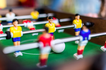 Children playing a colorful table football game