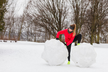 Woman wearing sportswear exercising during winter