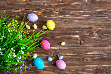 Hand-painted easter eggs with tulips on wooden background