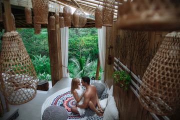 Honeymoon at Bali, Ubud. Successful couple relaxing at villa, beautiful view