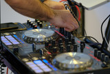 DJ plays mix on controller at a disco