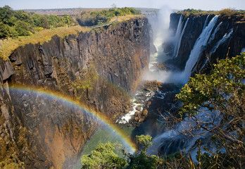 Victoria Falls. A general view with a rainbow. National park. Mosi-oa-Tunya National park. and World Heritage Site. Africa. Zambiya. Zimbabwe. 