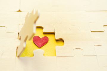 Heart and puzzles. Symbol of heart it is hidden under a part wooden puzzles. Romantic image