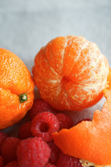 Whole peeled orange with raspberries