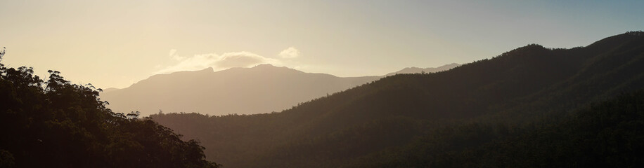 the sun lighting the south side of Mount Roland in Tasmania