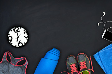 Fitness equipment on a black background. Concept of healthy lifestyle, sport and activity. Flat lay composition.