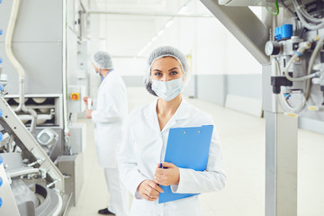 Technologist woman at food factory .