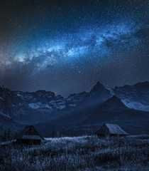 Milky way over Tatra mountain and small cottages, Poland