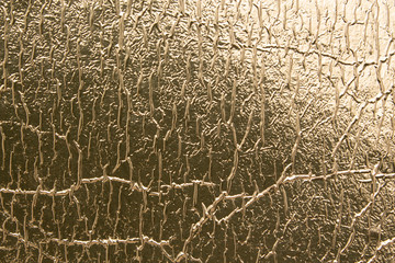 Texture of gold foil with folds, abstract background.