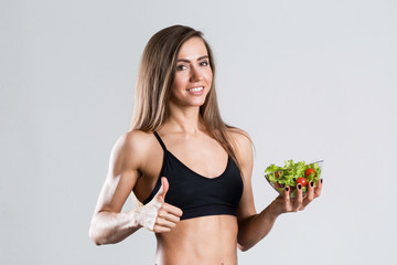 Fit woman with a salad isolated.